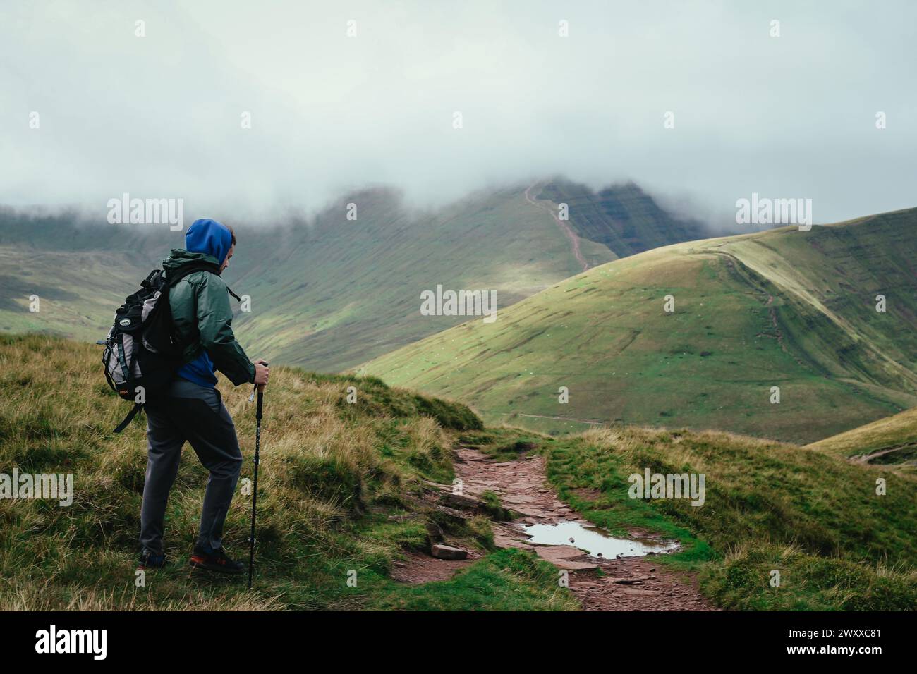 Man hiker in hood walking hi-res stock photography and images - Alamy
