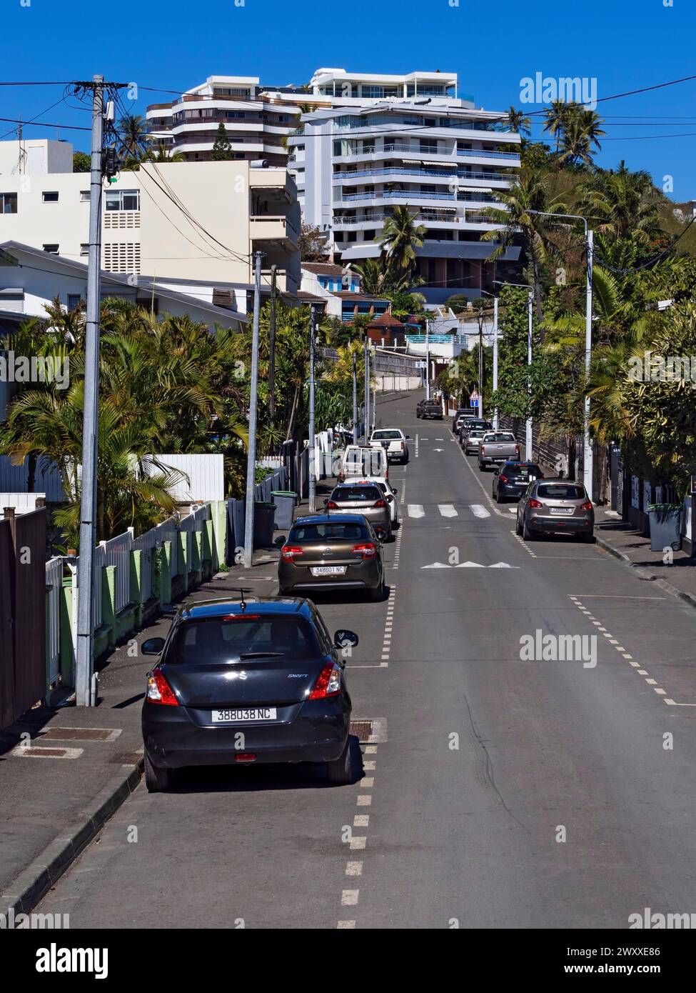 South Pacific Cruise / Street view with parked cars and homes in Noumea