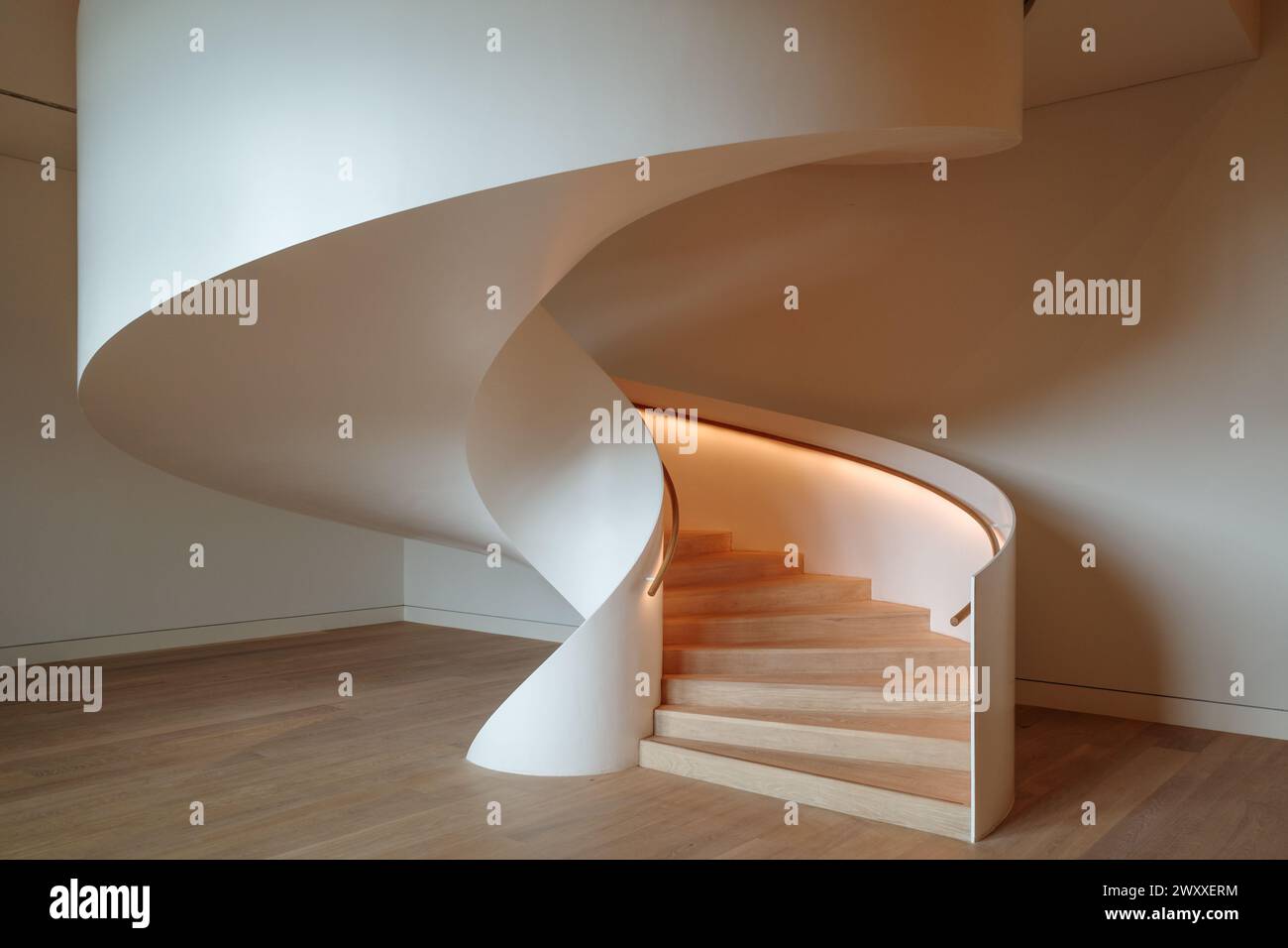 An exquisite view of a modern spiral staircase, encapsulating the sleek and minimalist aesthetic of contemporary architecture. Stock Photo