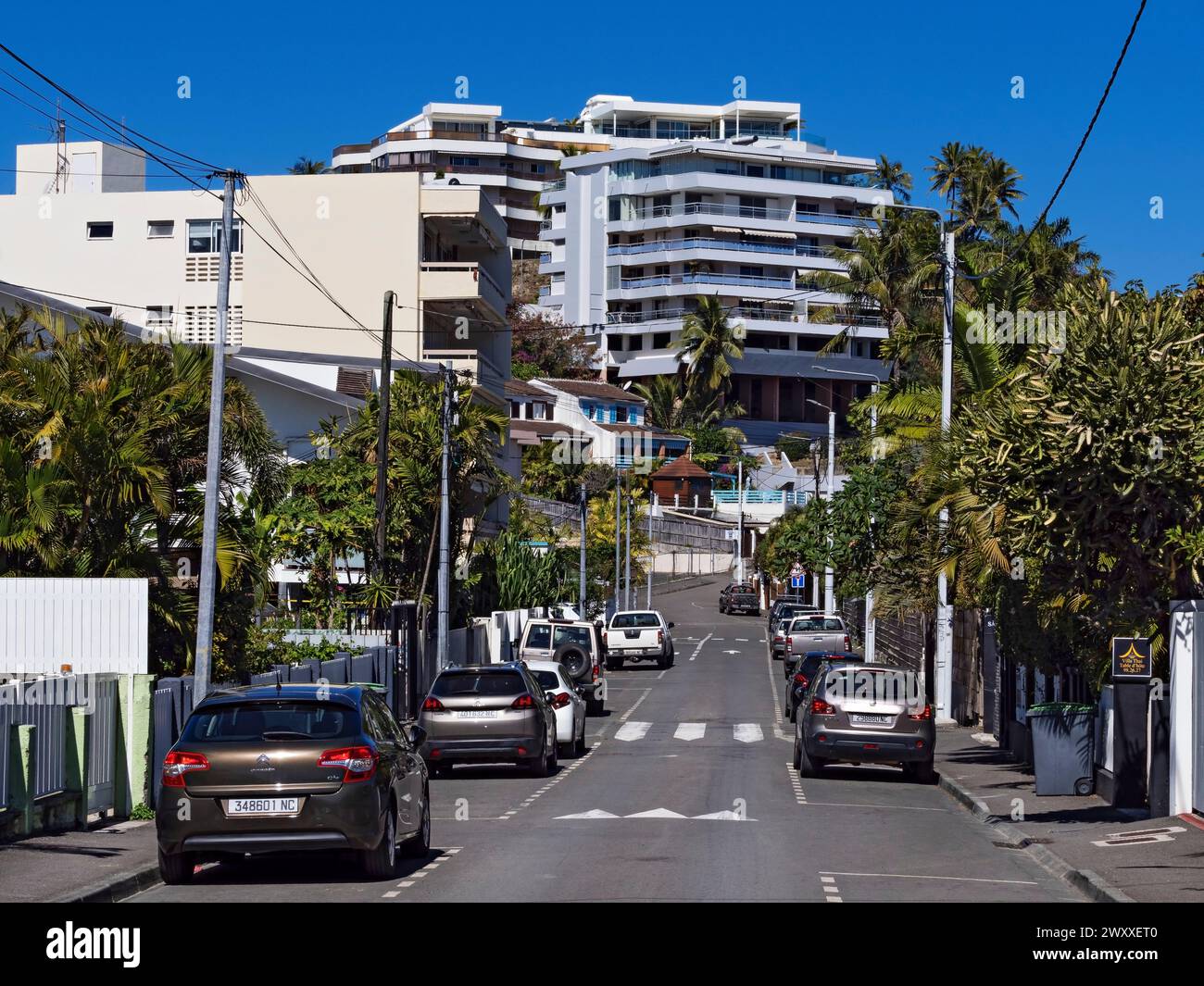 South Pacific Cruise / Street view with parked cars and homes in Noumea