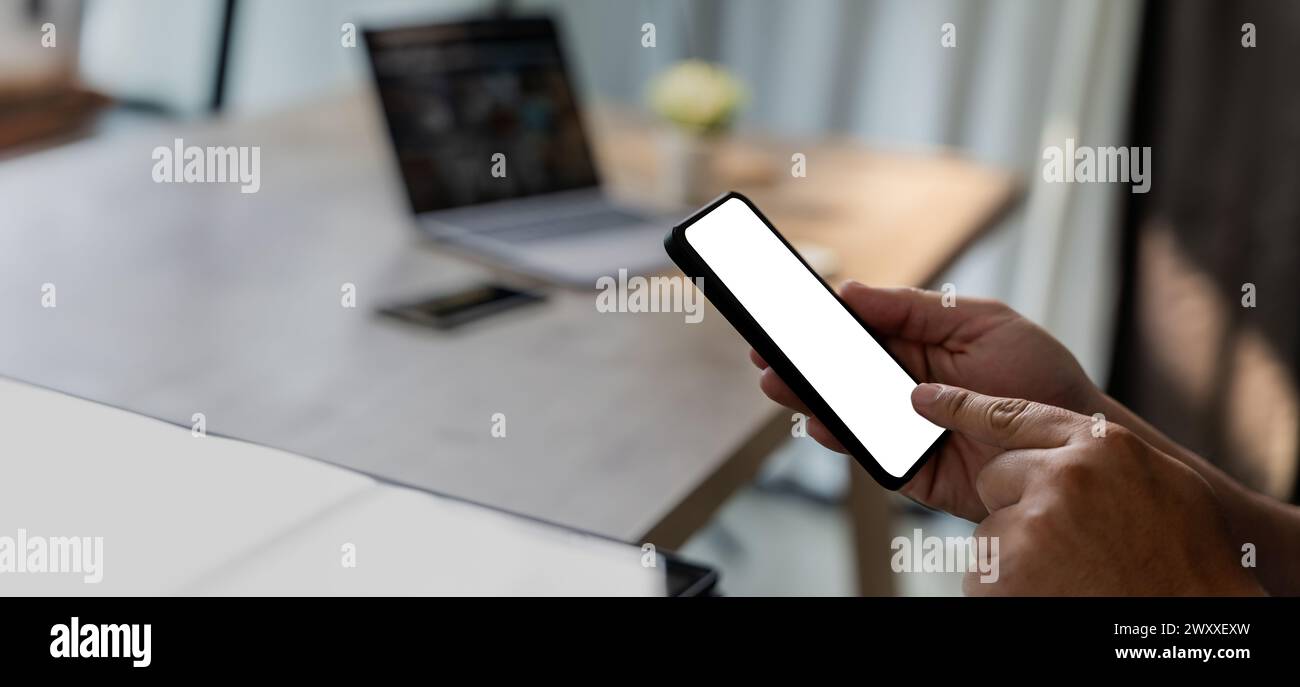 Top view Mockup image hand using a smartphone man Holding Cell Phone With Blank Screen Stock Photo