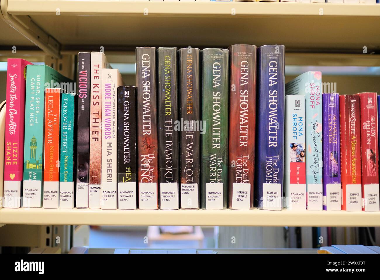 Library shelf with book titles by bestselling American author Gena Showalter; paranormal contemporary romance novels and books; young adult fiction. Stock Photo