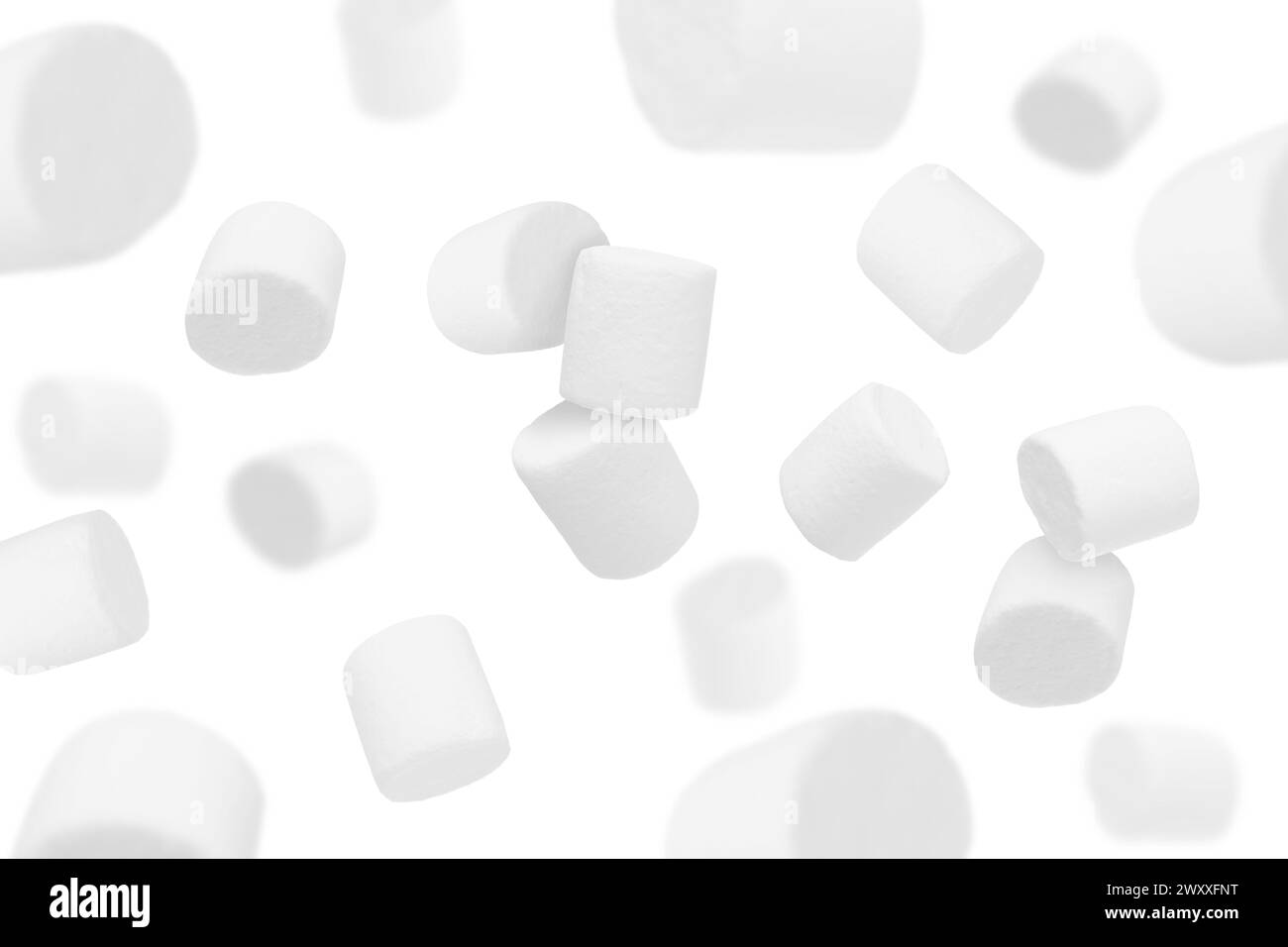 Many yummy marshmallows flying on white background Stock Photo - Alamy