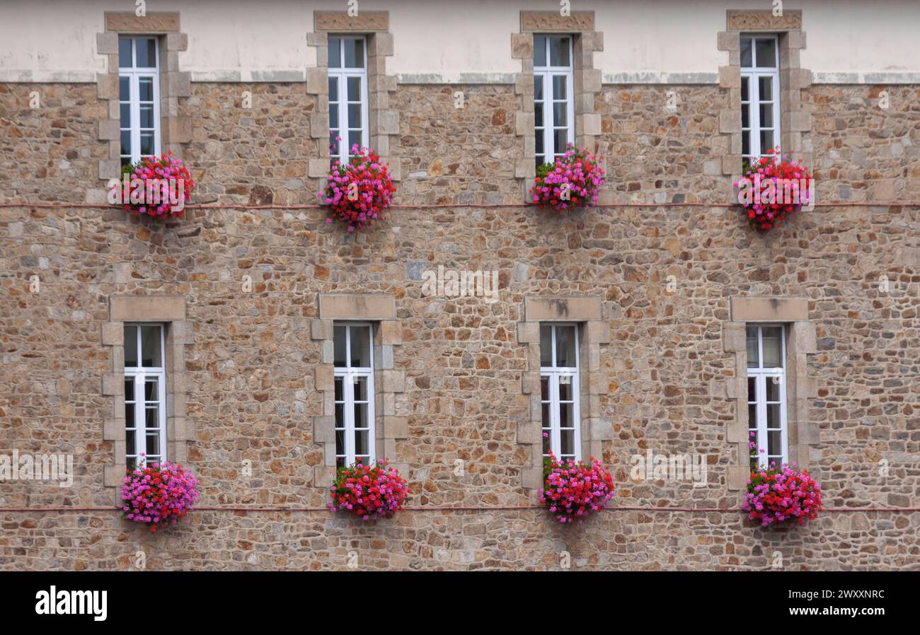 House facade with narrow windows and floral decorations, Hotel de Ville, town hall, Guingamp, Departement Cotes-d'Armor, Brittany, France Stock Photo
