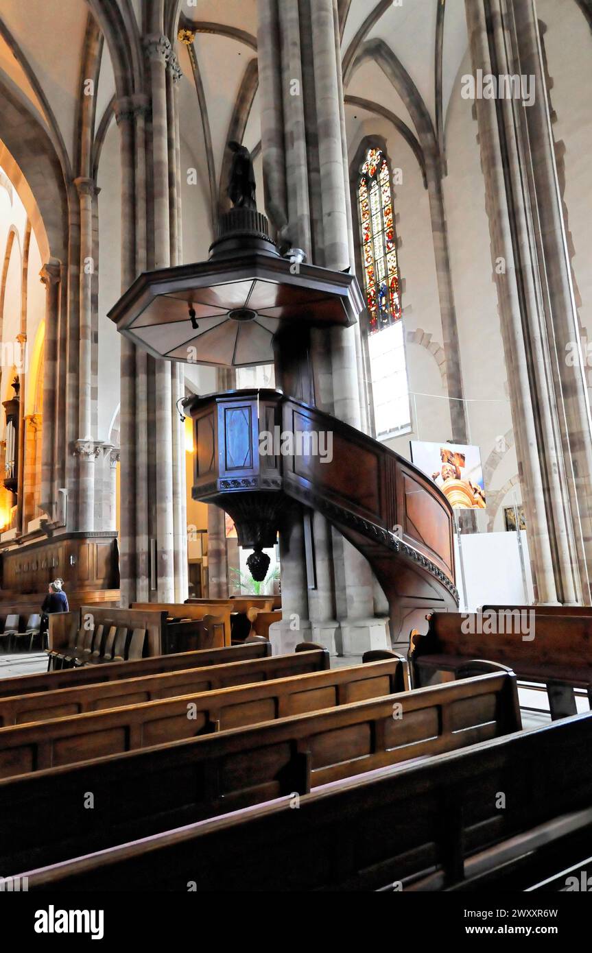 The Lutheran Church of St Thomas, Eglise Saint Thomas de Strasbourg, Alsace, pulpit and pews in a Gothic church interior with stained glass windows Stock Photo