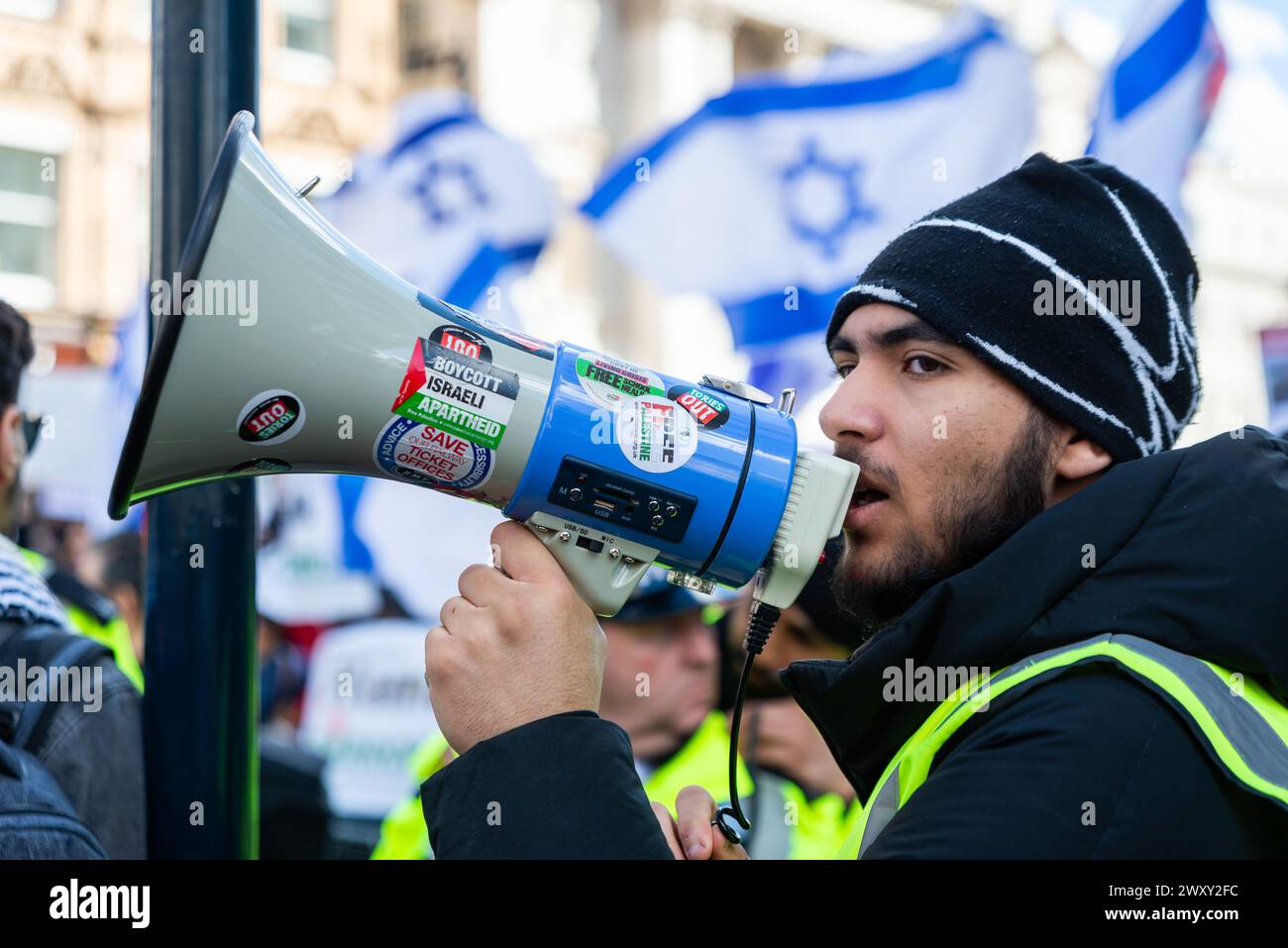 Protest against the conflict between Israel and Hamas continues. Pro Palestine protester by Israel flags of counter protesters Stock Photo