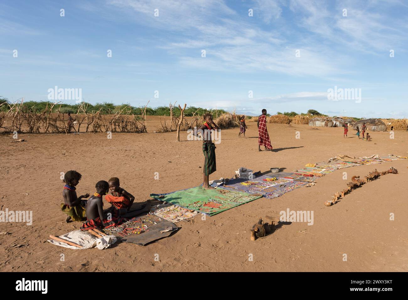 Omorate, Omo Valley, Ethiopia - May 11, 2019: Children from the African tribe Dasanesh offering handmade souvenirs. Daasanach are Cushitic ethnic grou Stock Photo