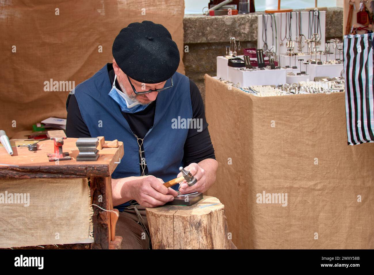 Baiona, Pontevedra, Spain; March,06,2022; Goldsmith craftsman makes bracelets during the Arribada festival that celebrates the arrival of the Caravel Stock Photo