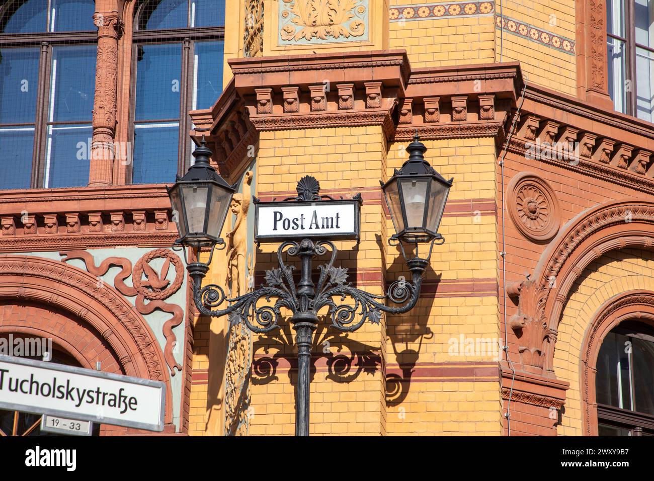 sign Post office building - (Kaiserliches Postfuhramt -  on Oranienburger street crossing Tucholsky street in Berlin, Germany Stock Photo