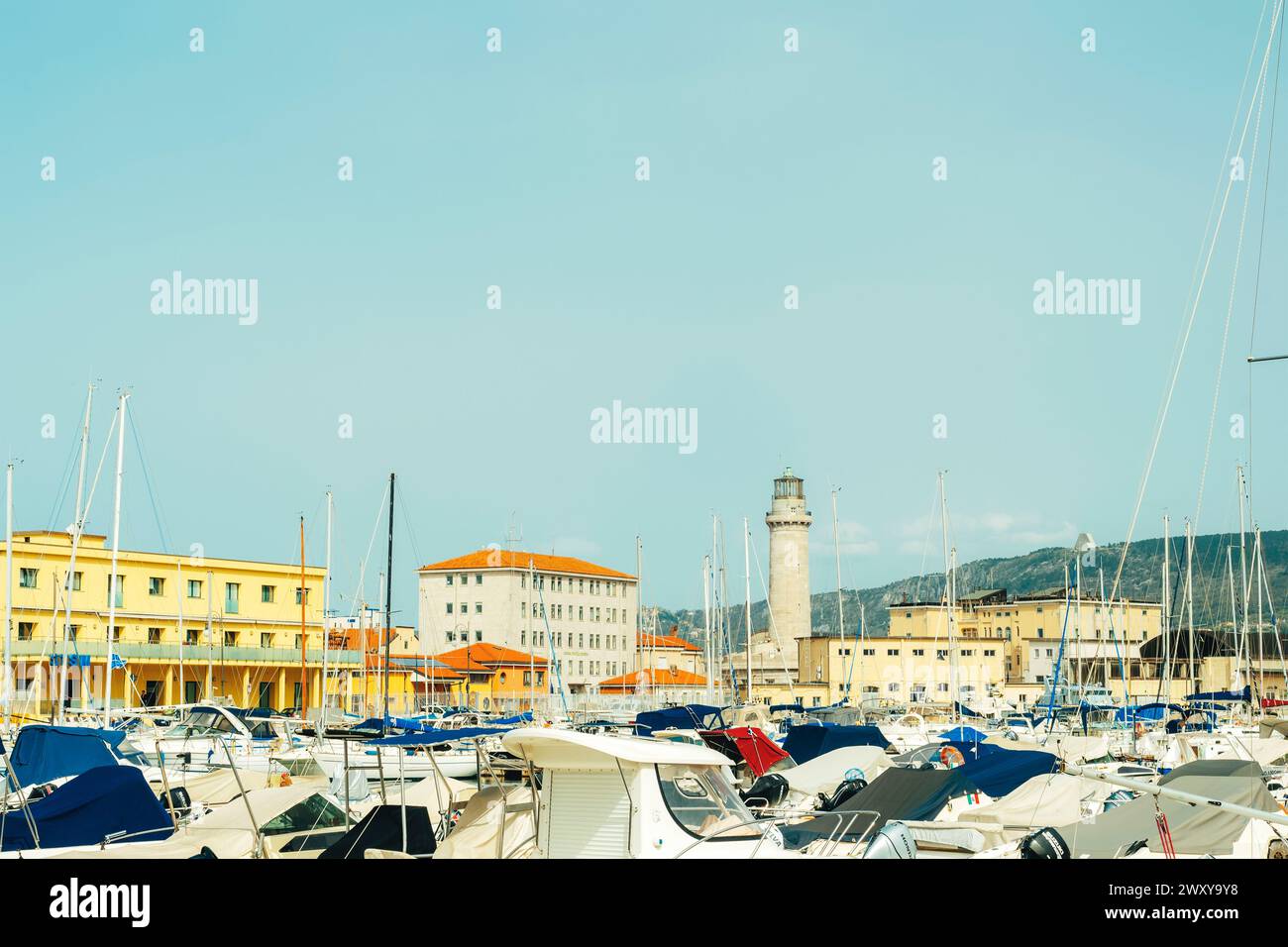 Trieste Italy - 30 march 2024: View of the pier and lighthouse against a blue sky. Stock Photo