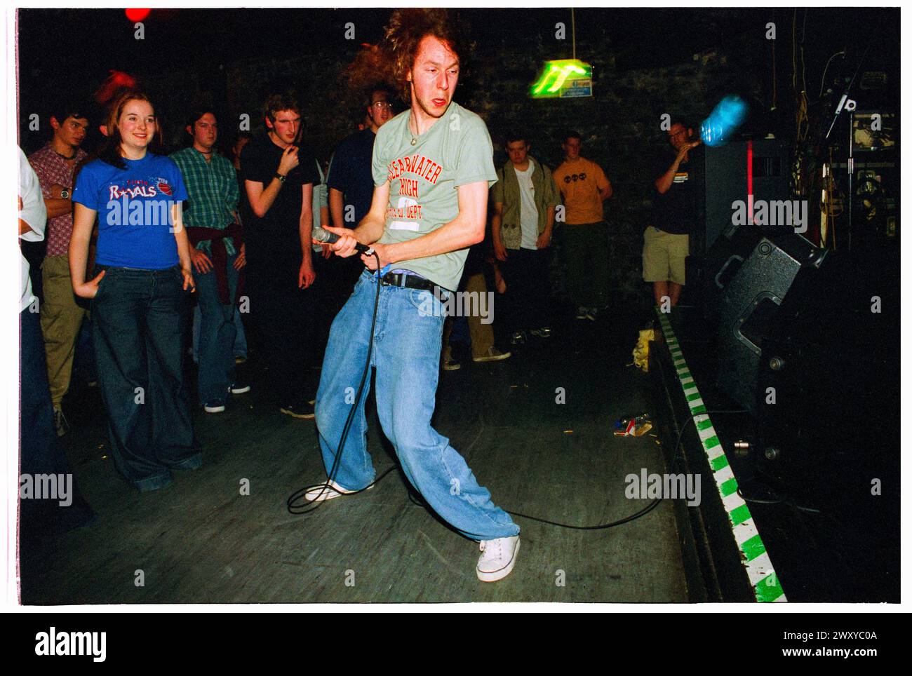 HUNDRED REASONS, EMO CONCERT, 2001: Colin Doran of the Emo rock band Hundred Reaons jumps out into the crowd playing at Clwb Ifor Bach Welsh Club in Wales, UK 14 May 2001. Photo: Rob Watkins.  INFO: 100 Reasons, a British post-hardcore rock band formed in 1999 in London, gained acclaim for their energetic live performances and emotive songwriting. Hits like 'If I Could' and 'Silver' showcased their dynamic sound, earning them a devoted following in the early 2000s music scene. Stock Photo