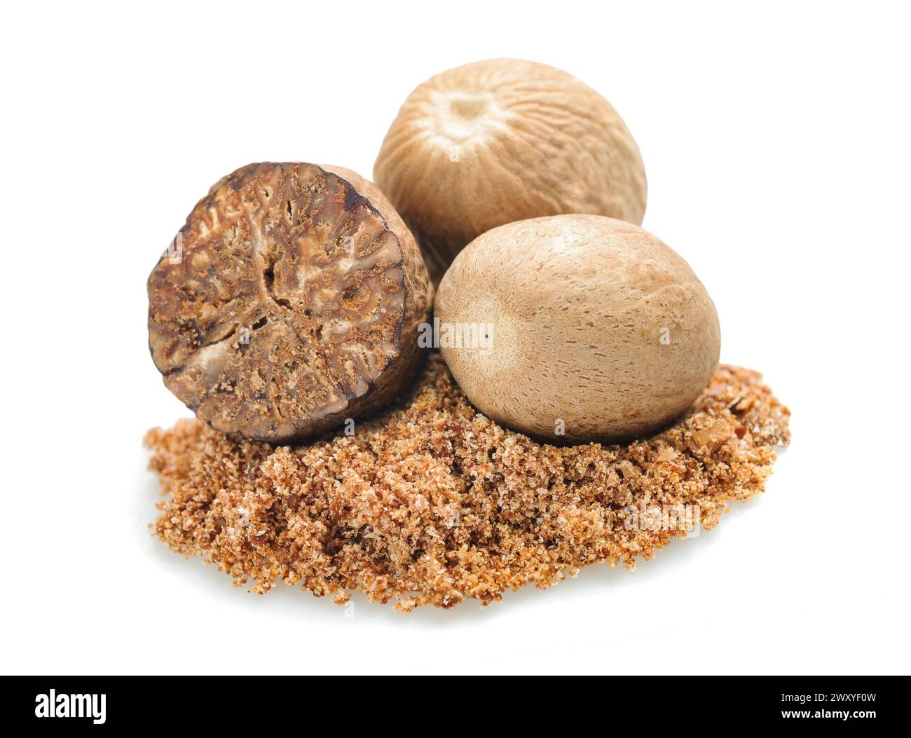 Nutmegs and grated nutmeg isolated on white background Stock Photo