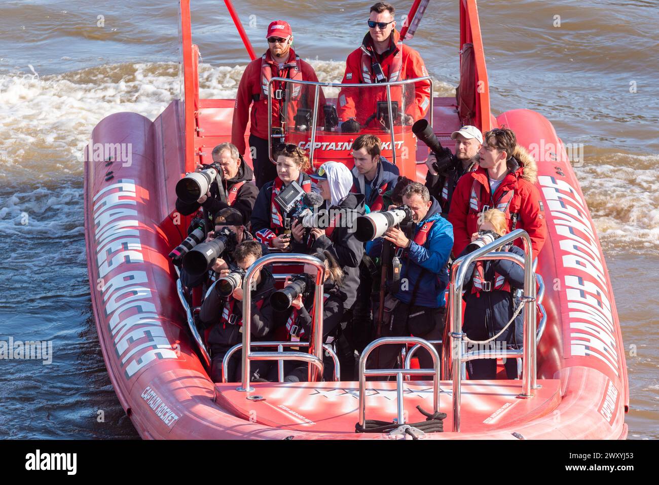 Press photographers boat at the University Boat Race on the River Thames near the finish at ...