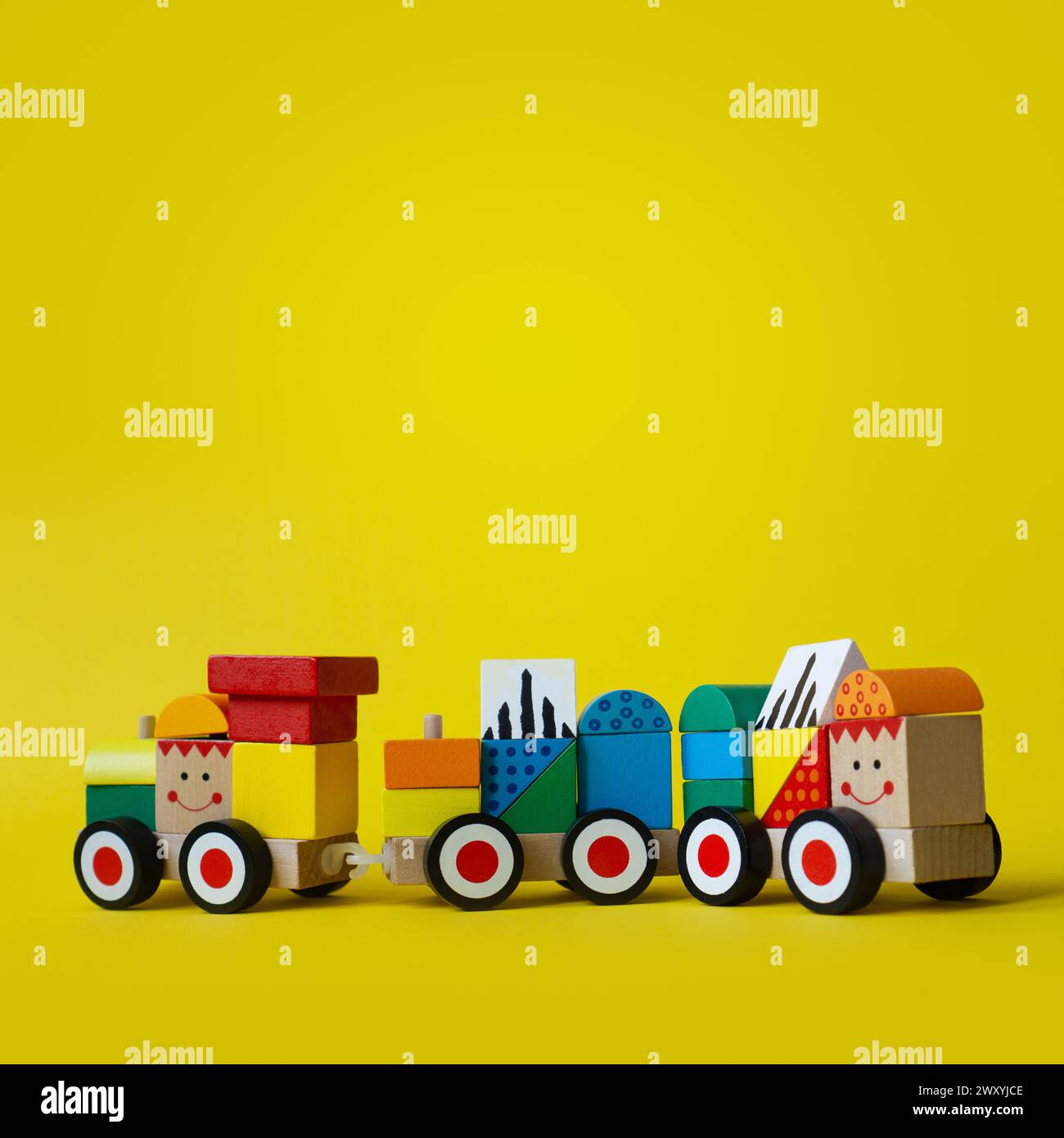 Colorful wooden train on wheels. Sorter type of blocks for early child development. Eco friendly toy. Vivid and bright background with copy space. Stock Photo