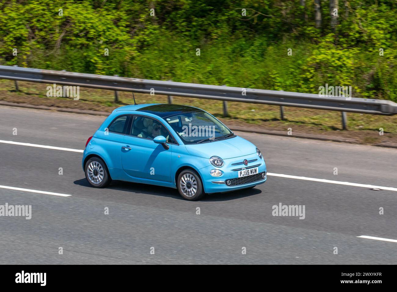 2015 Blue Fiat Lounge S-A Dualogic Auto Start/Stop 1242 cc petrol hatchback travelling on the M6 motorway, UK Stock Photo