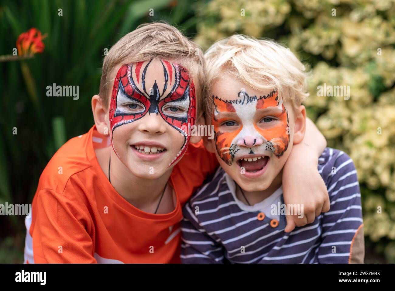 Two happy cute little boys with their faces painted. Face painting