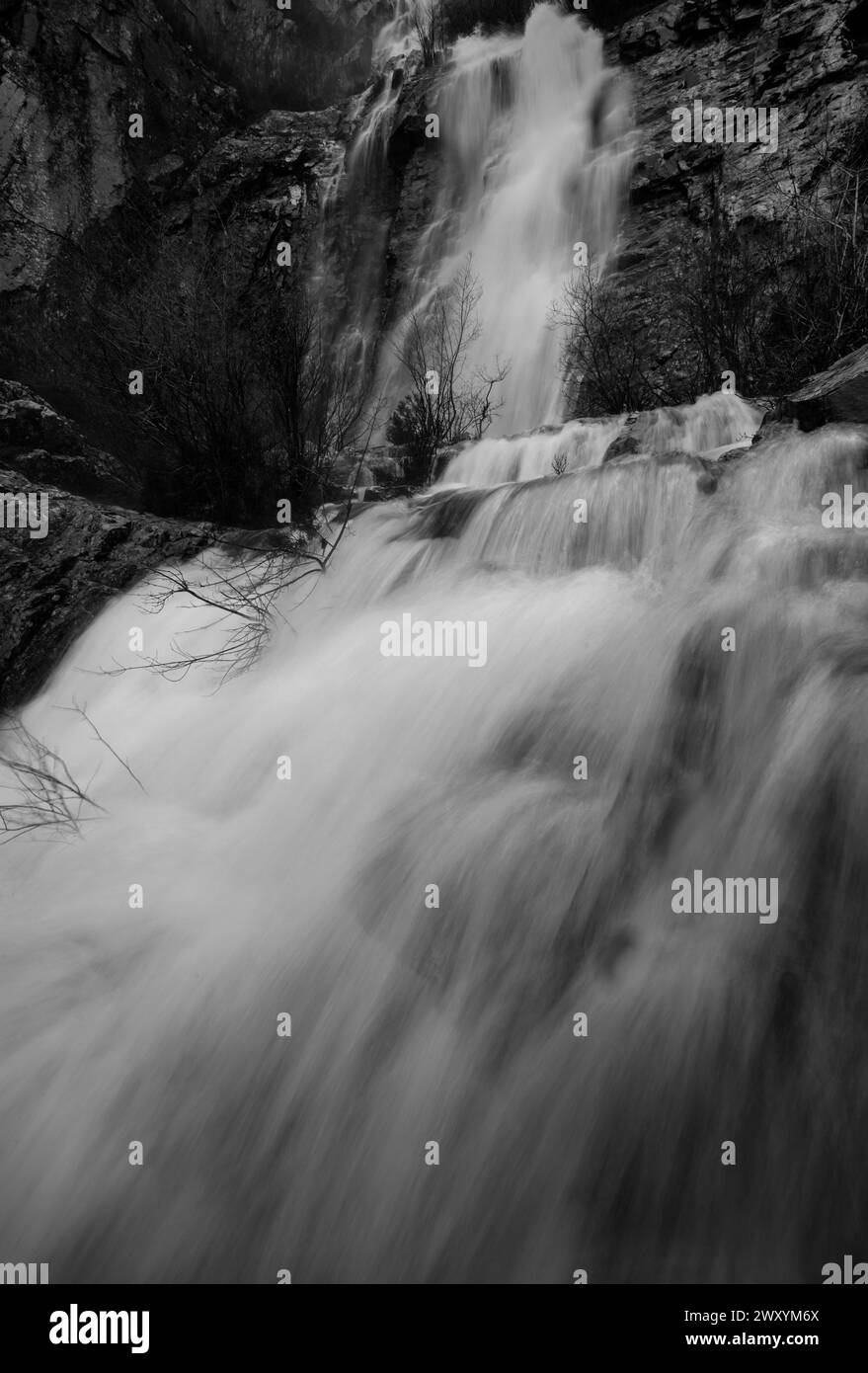 A black and white capture of the Rio Mundo Waterfall, showcasing the raw power and graceful motion of cascading water Stock Photo