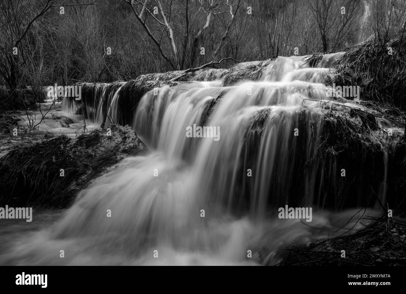 The powerful movement of water over Rio Mundo's natural rapids is captured in stunning detail in this monochromatic image Stock Photo