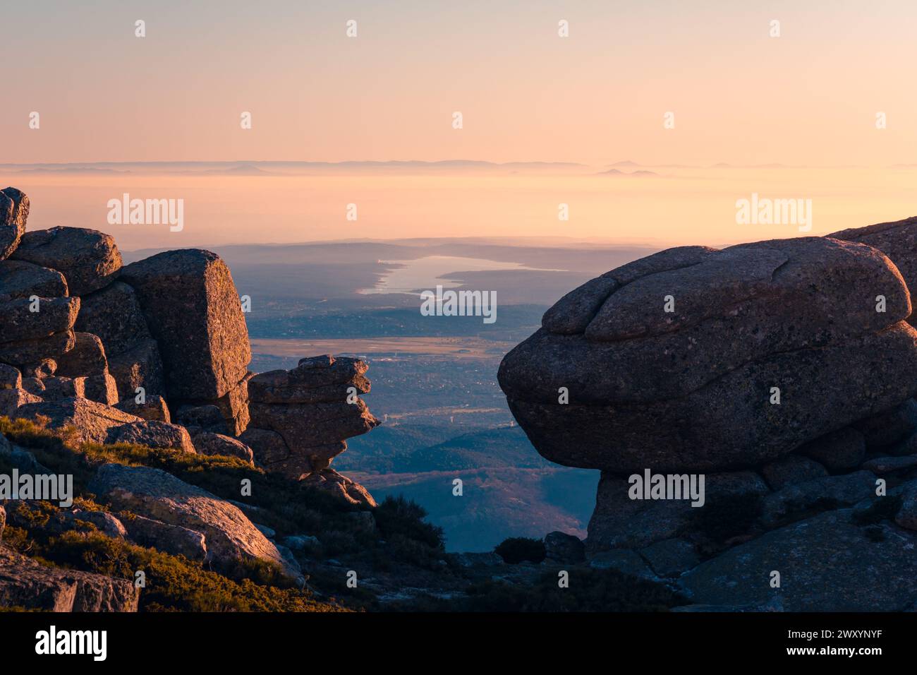 Sunset view from Siete Picos with silhouettes of rocks and distant mountains in the backdrop Stock Photo