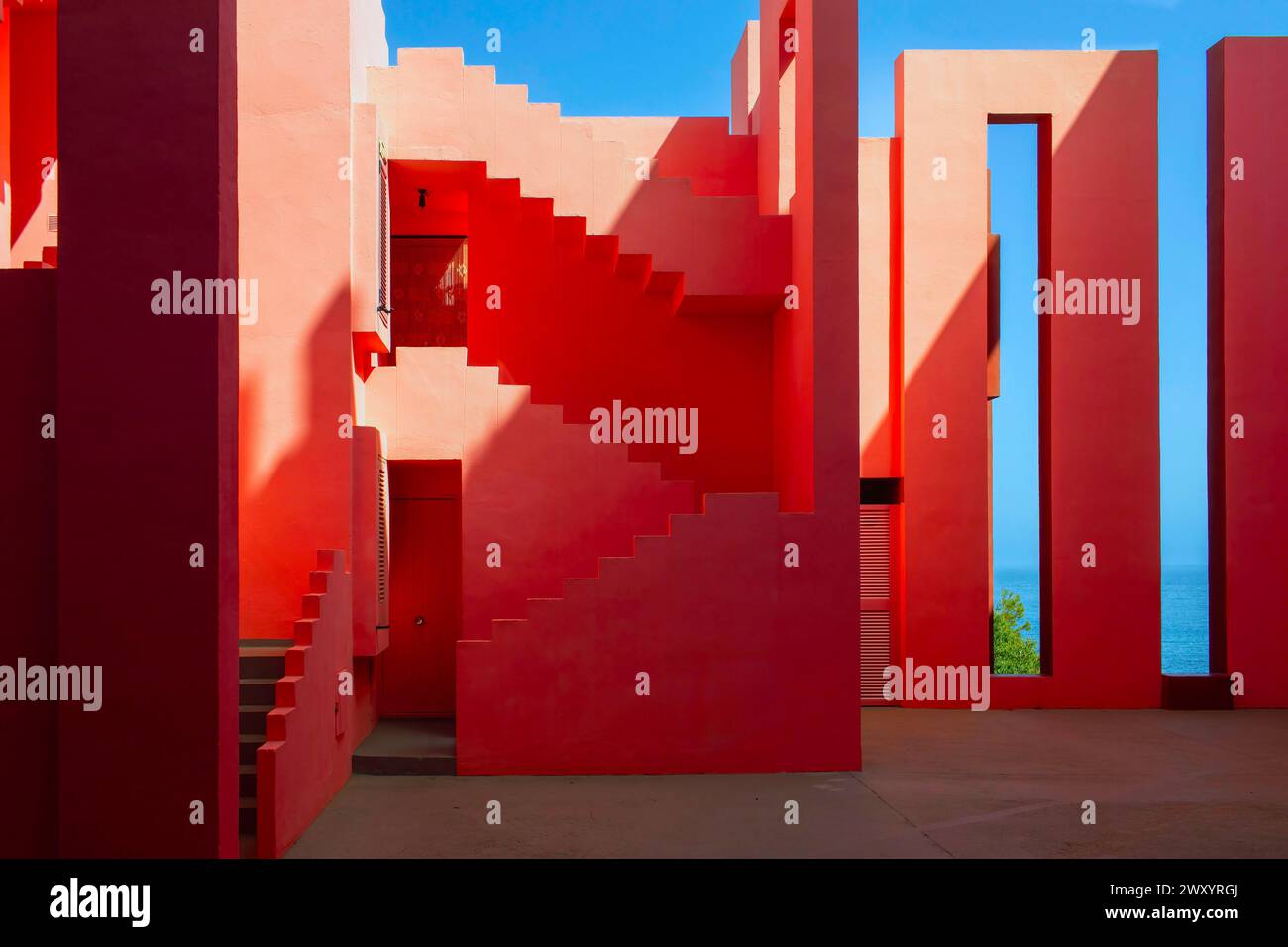 Spain, Calpe (or Calp): La Muralla Roja (The Red Wall), apartment complex along the Costa Blanca designed by architect Ricardo Boffil. Architectural d Stock Photo