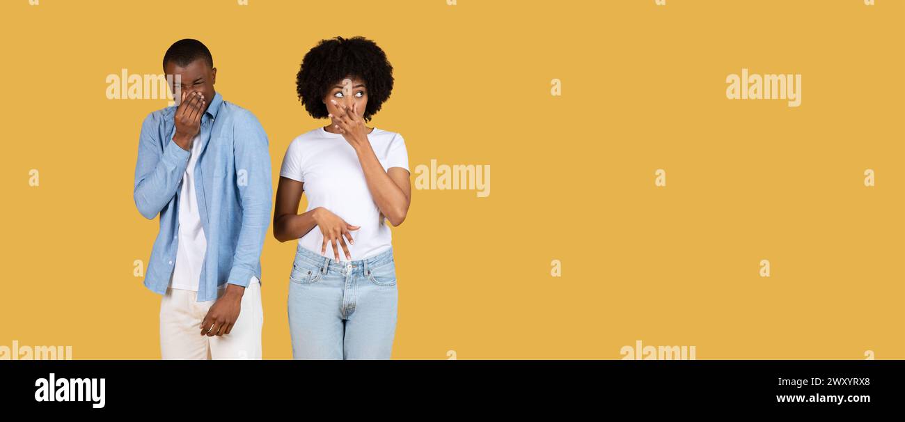 Two people holding noses, disgusted, panorama with copy space Stock Photo