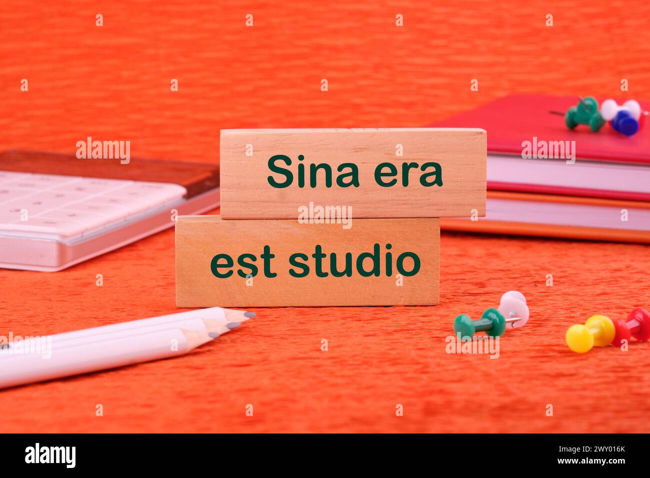 Sina era est studio It means Without anger and addiction on a wooden block next to office supplies Stock Photo