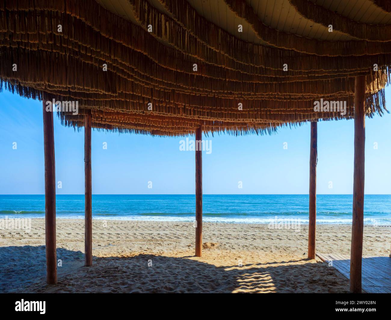 Thatched roof on the beach of Estepona, Málaga Stock Photo
