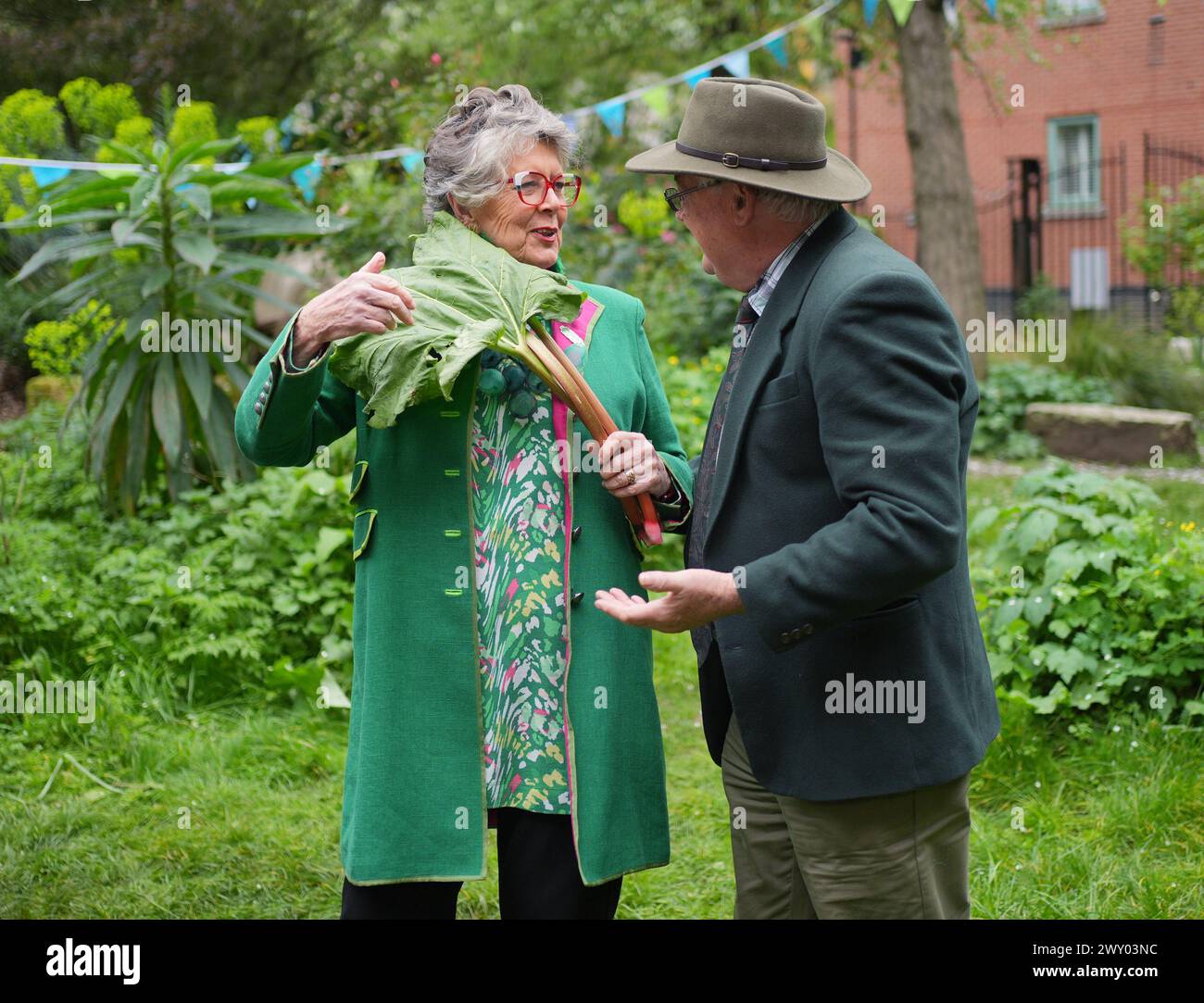 Prue Leith is presented with rhubarb from Brian Hickey, of Southend, Essex, during the launch event for this year's The Big Lunch at the Phoenix Garden, a community garden in London. The Big Lunch, on June 1-2, encourages community gatherings which raise money for good causes and gets people together. £87m has been raised for good causes at Big Lunch events since 2015. Picture date: Wednesday April 3, 2024. Stock Photo