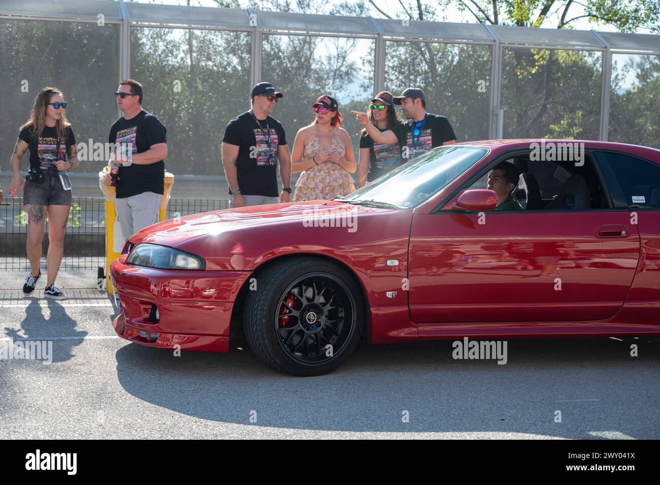 Front view of a red ninth-generation Nissan Skyline GT-R33 at a Japanese sports car meet. Stock Photo