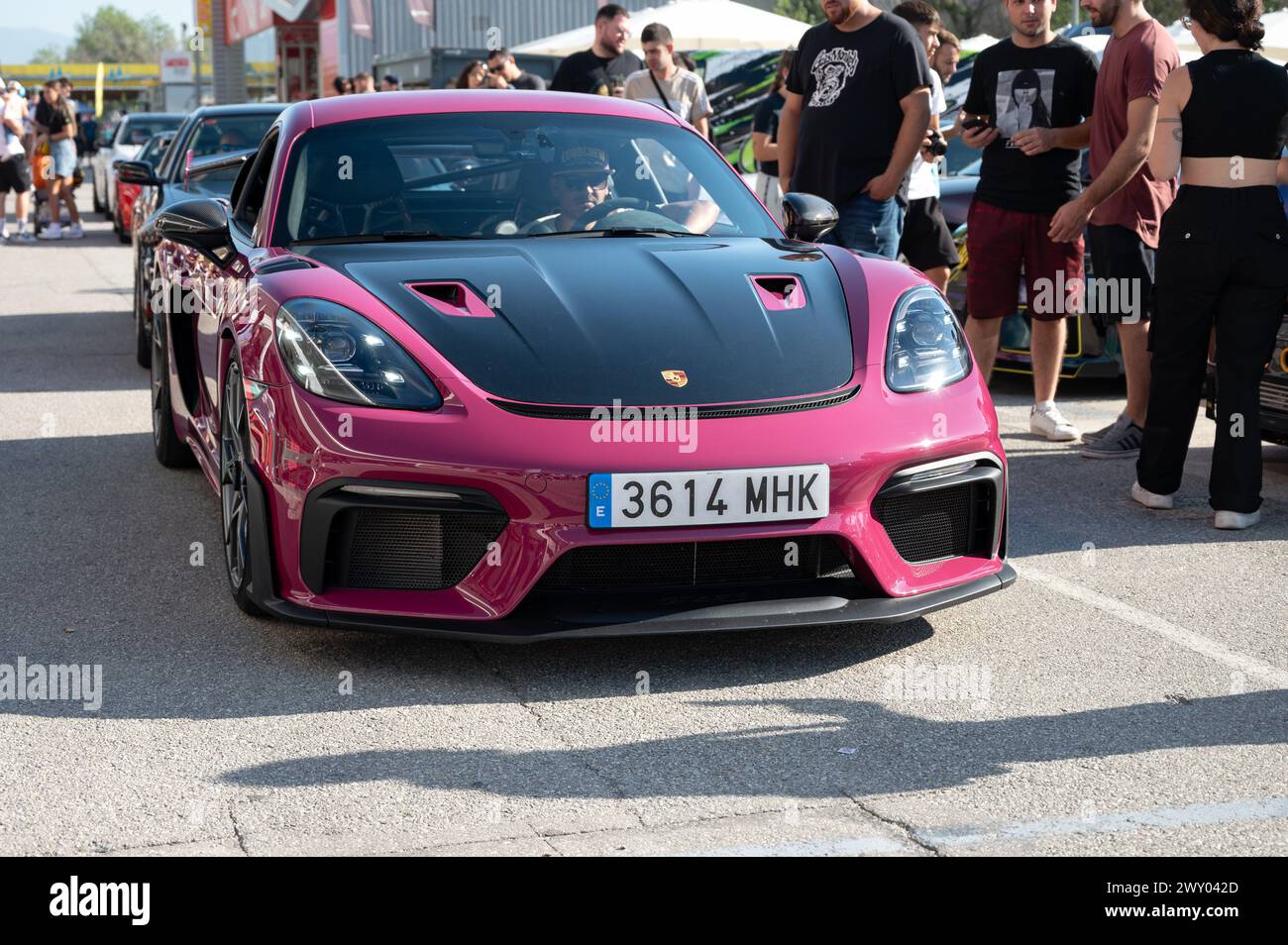 Front view of a German sports car, the pink Porsche 718 Cayman GT4 RS with a black carbon fiber hood. at a car meeting Stock Photo