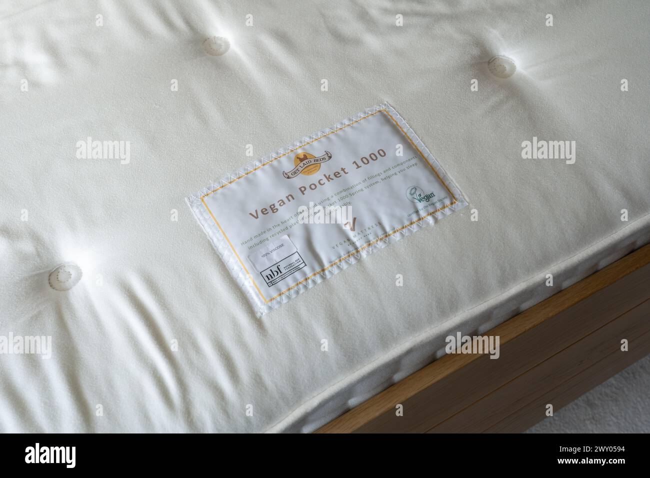 Get Laid Beds pocket spring mattress with a label certifying it as vegan by the UK Vegan Society. Concept: veganism, vegan products, vegan product Stock Photo
