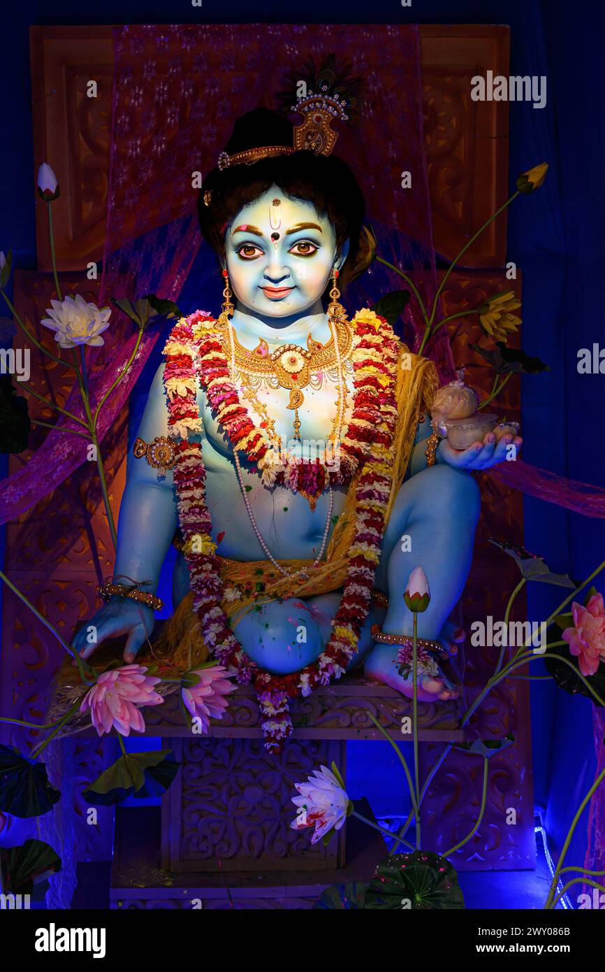 Idol of Goddess Laddu Gopal or little Lord Krishna at a decorated puja pandal in Kolkata, West Bengal, India on March 26, 2024. Stock Photo