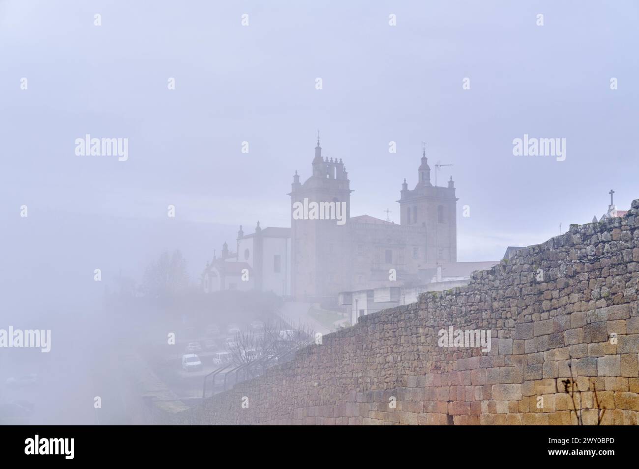 The Cathedral of the walled city of Miranda do Douro in the fog. Trás-os-Montes, Portugal Stock Photo