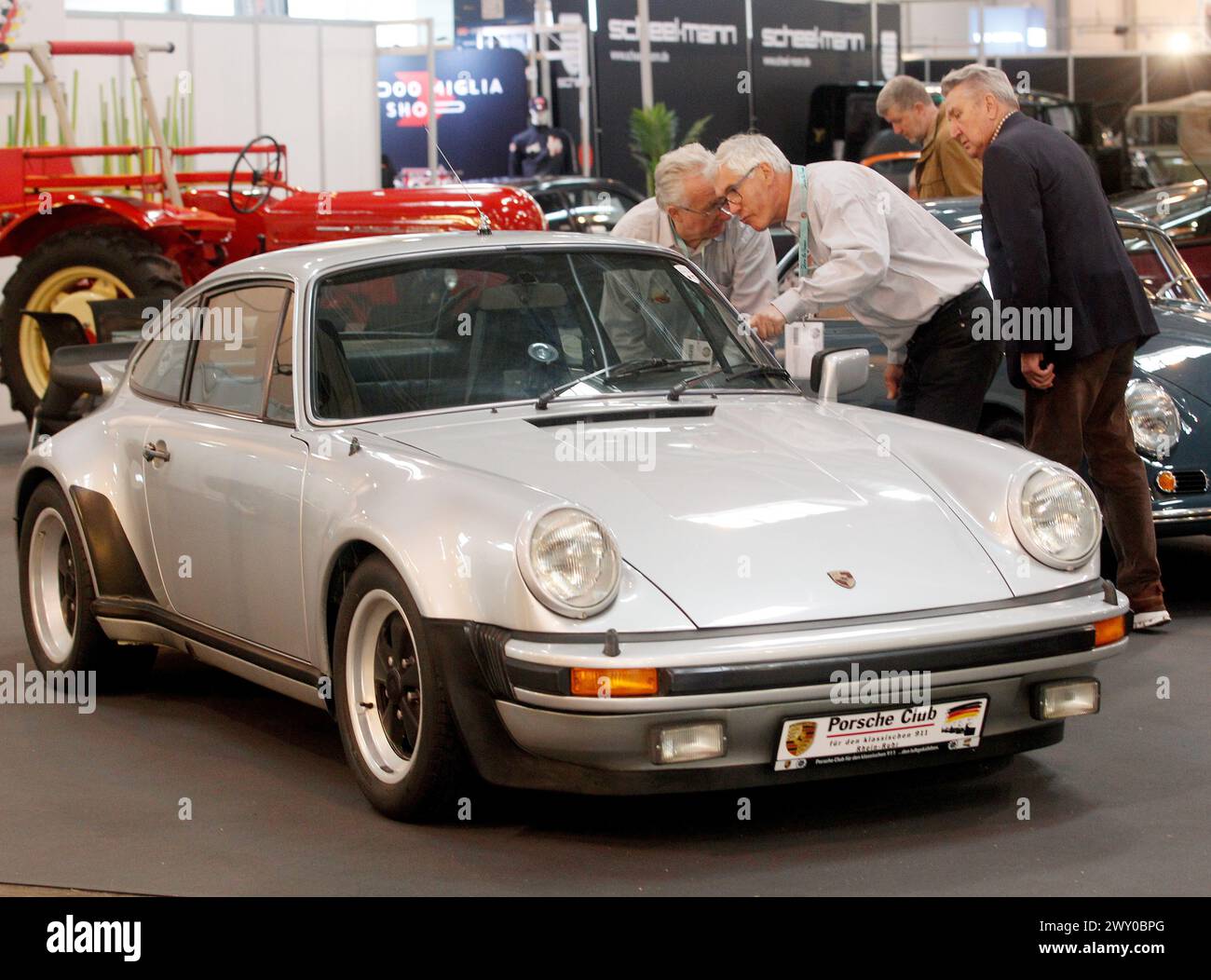Essen, Germany. 03rd Apr, 2024. Visitors take a look at a Porsche Turbo from 1987 at the 'Techno Classica' classic car show. Techno-Classica is one of the largest classic car shows in the world. More than 2700 classic cars are on display at prices ranging from under 10,000 to several million euros. Credit: Roland Weihrauch/dpa/Alamy Live News Stock Photo