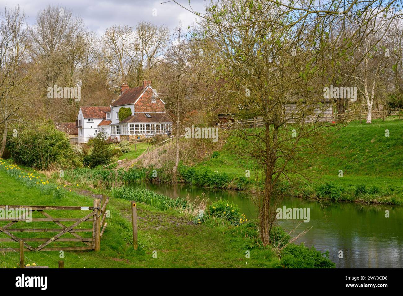 The Mill House in a picturesque setting next to a stream and pond in