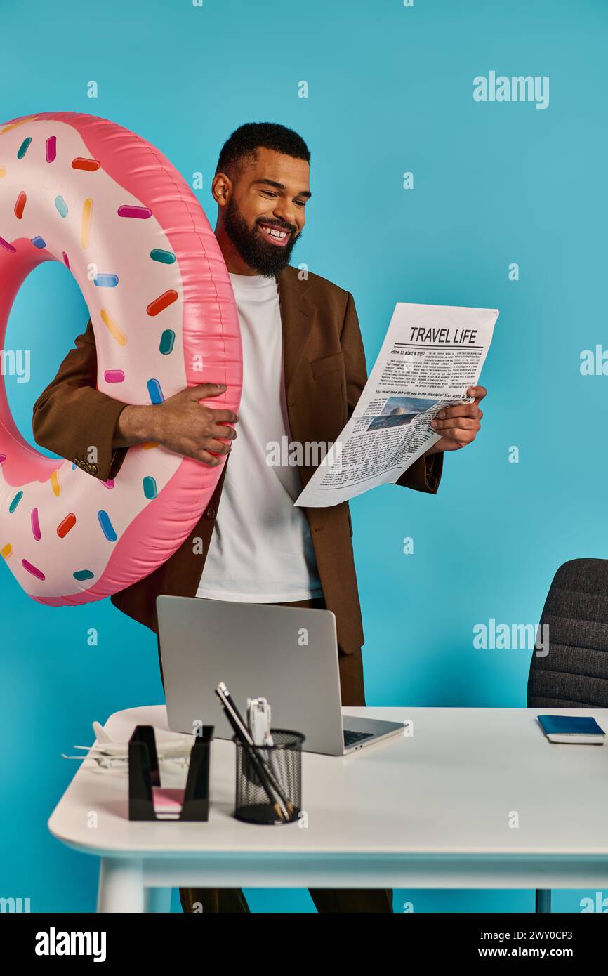 A man playfully holds a giant donut in front of his face, giving the illusion of wearing it like a mask. Stock Photo