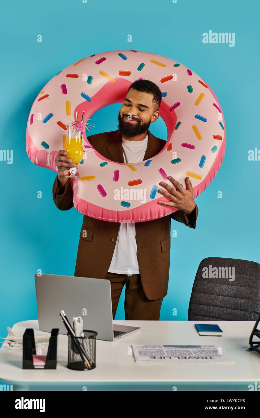 A man playfully holds up a giant donut in front of his face, creating a whimsical and humorous scene. Stock Photo