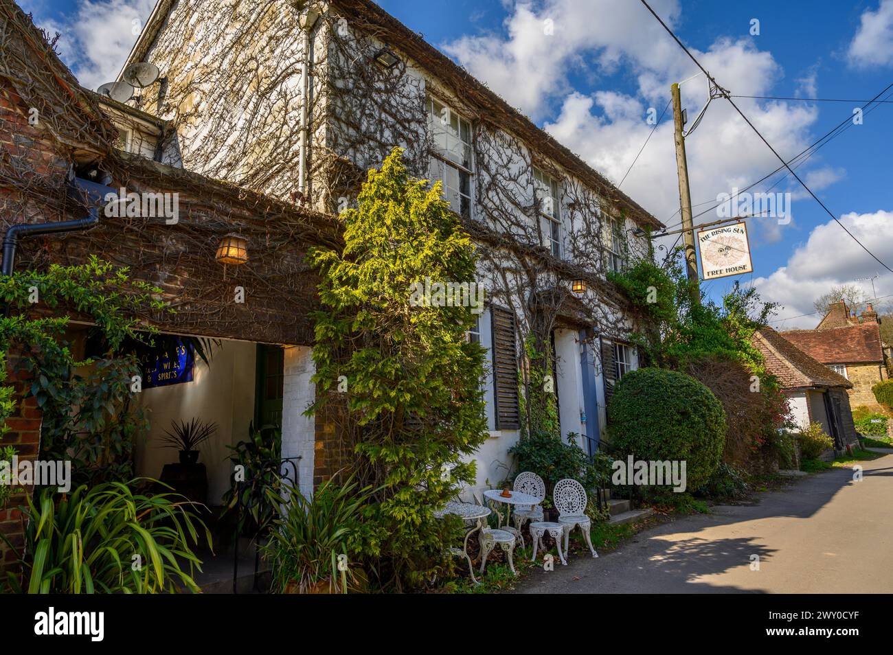 The front facade and sign of The Rising Sun, an old pub in Nutbourne village near Pulborough in West Sussex, England. Stock Photo