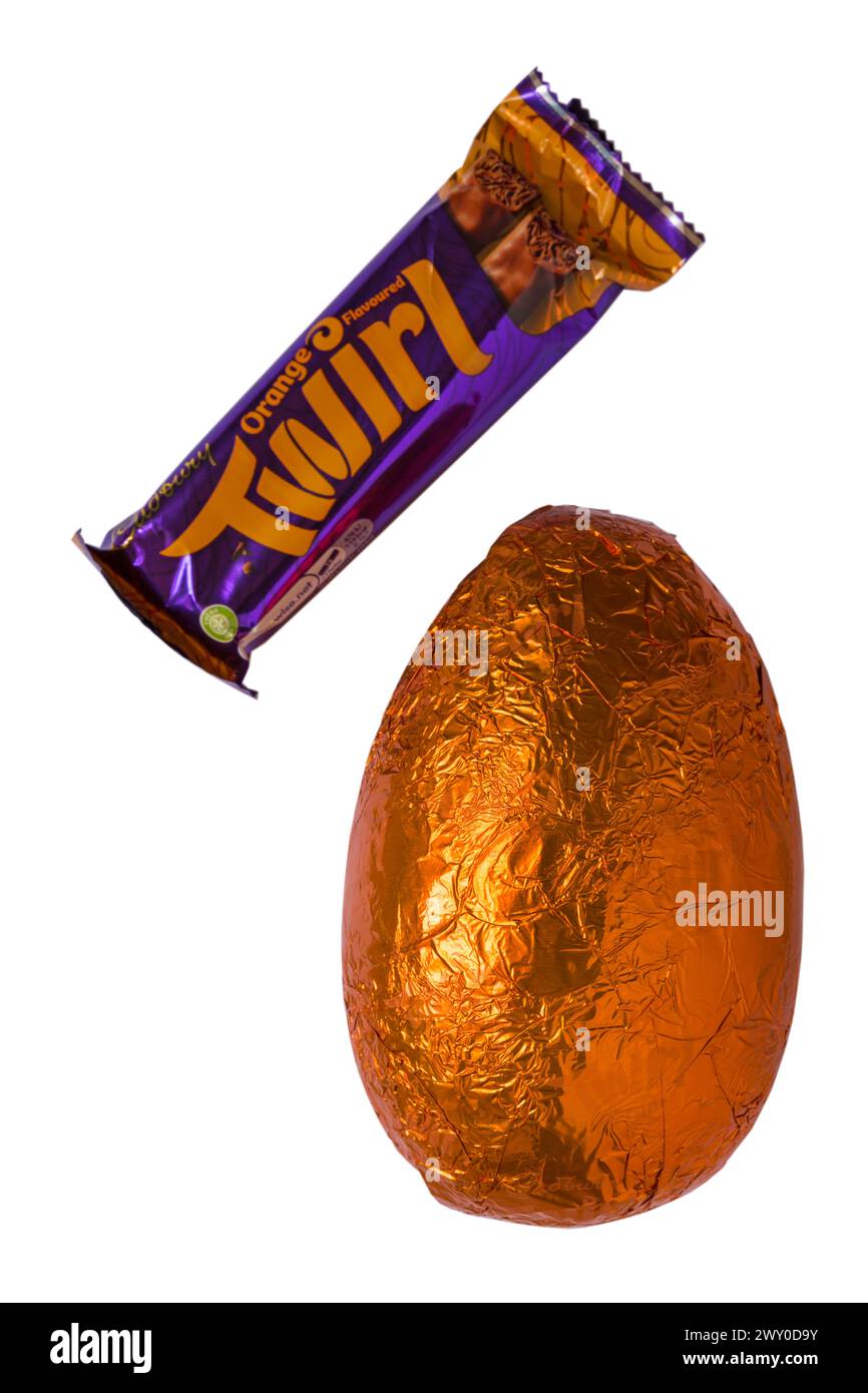 Cadbury Twirl orange Easter Egg foil wrapped and Twirl chocolate bar isolated on white background Stock Photo