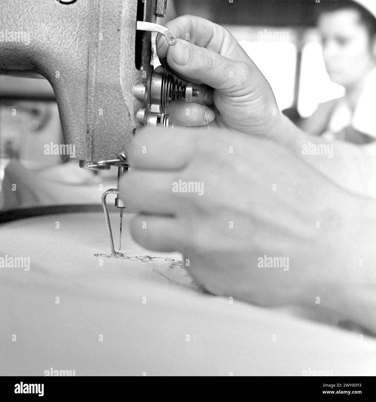 Socialist Republic of Romania in the 1970s. A seamstress using a sewing