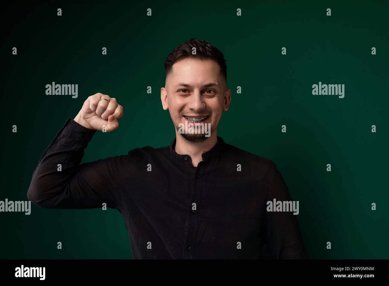 Man in Black Shirt Posing for Picture Stock Photo