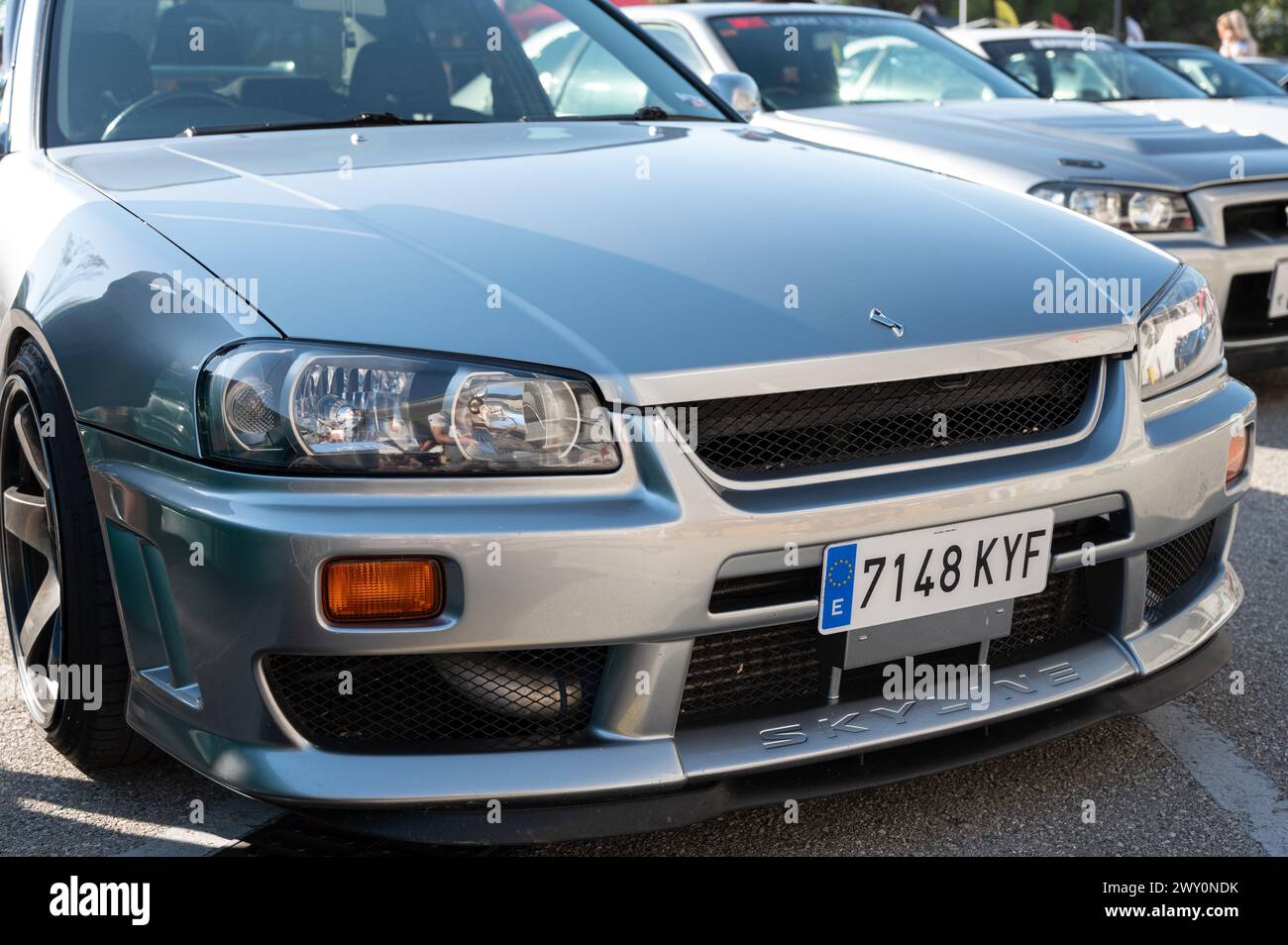 Front view detail of a silver tenth generation Nissan Skyline GT R34 in ...