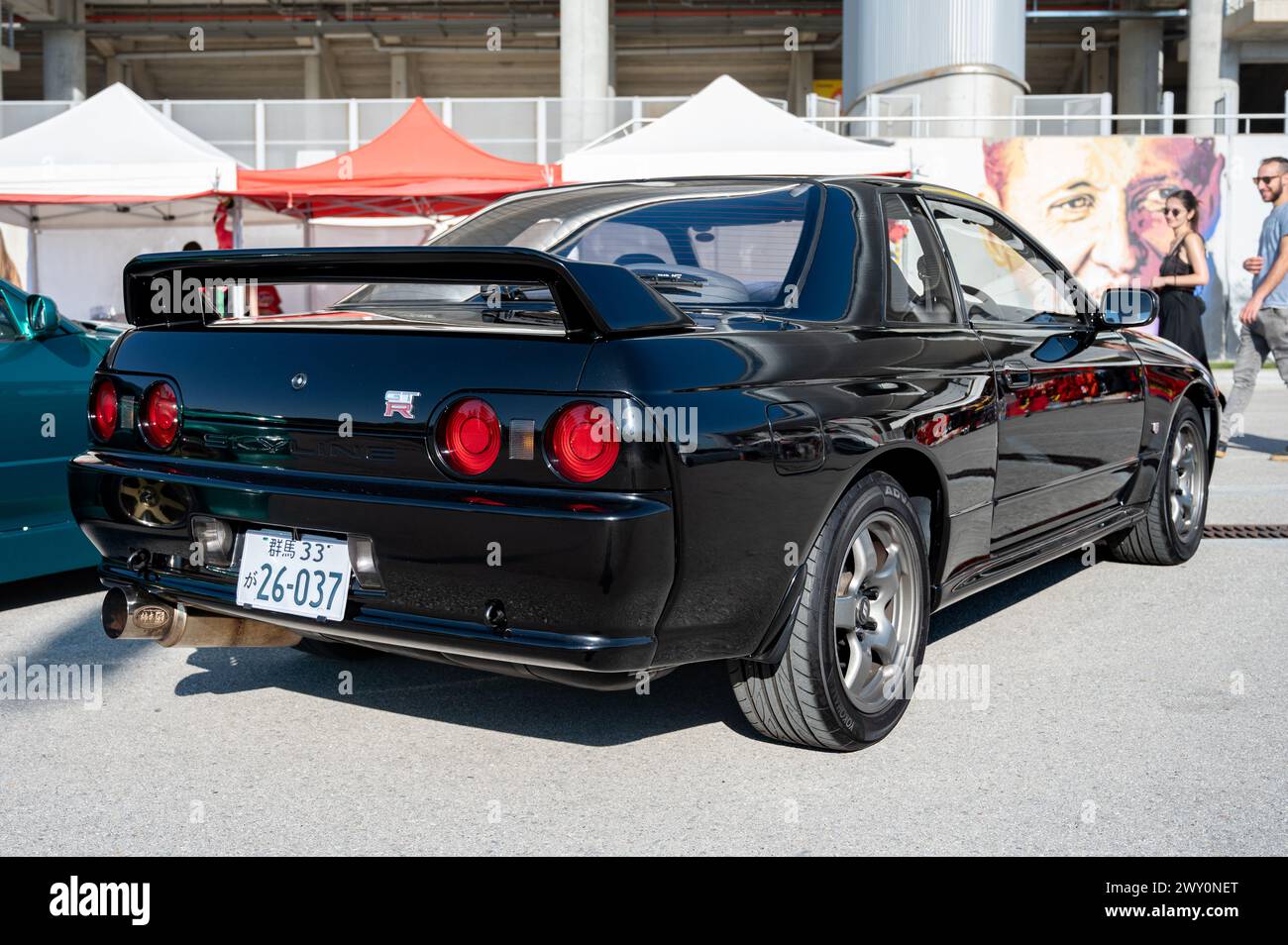 Rear view of a black eighth-generation Nissan Skyline GT R32 at a Japanese car meet Stock Photo