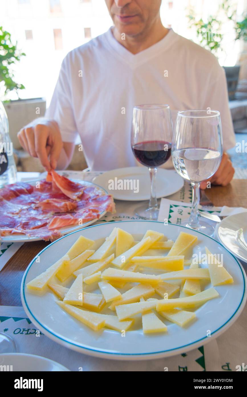 Cheese and Iberian ham servings in a terrace. Spain. Stock Photo