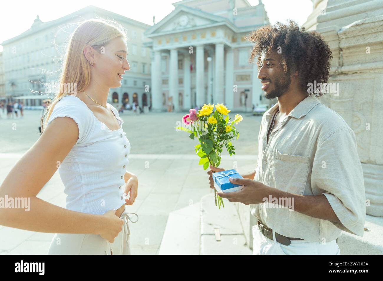 A man is about to propose to his future wife with flowers and a ring. Stock Photo