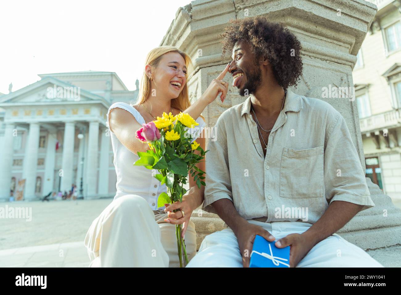 A loving couple spends a moment together, a man has a Valentine's gift for his partner. Stock Photo