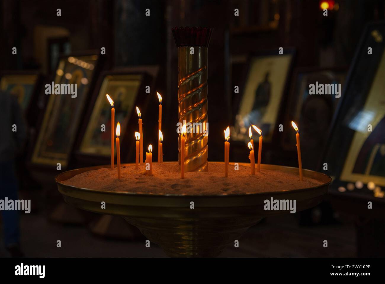 Burning candles in front of icons Stock Photo - Alamy