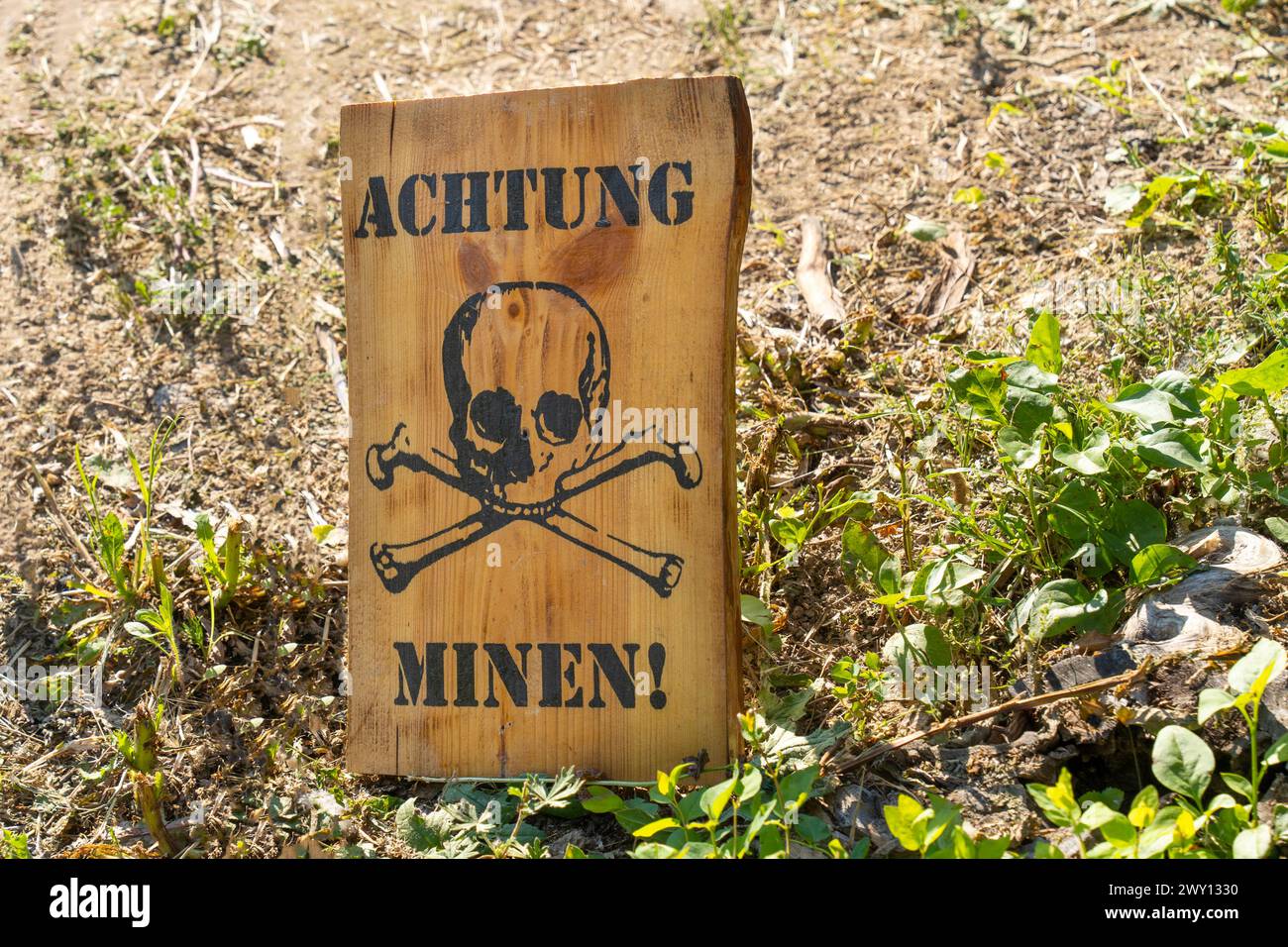 World War II minefield warning sign with German inscription and skull Stock Photo