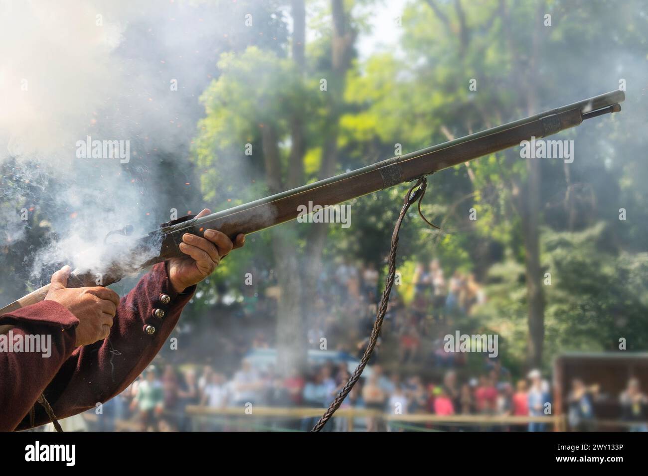 The flint firing mechanism of a medieval rifle in a man's hand Stock Photo