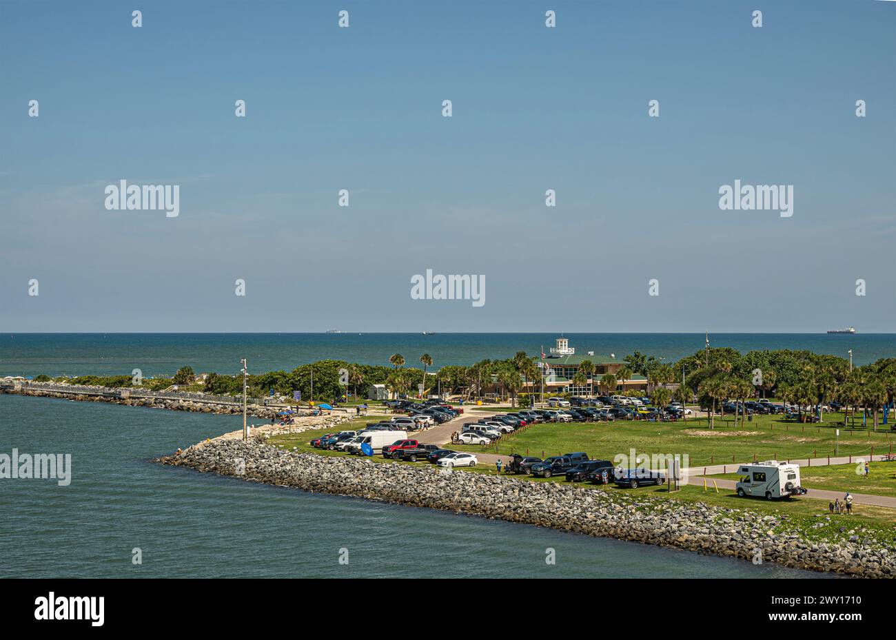 Port Canaveral, Florida, USA - July 30, 2023: Full parking at seagate exit of port where Fishlips restaurant and bar with green roof near beach and At Stock Photo